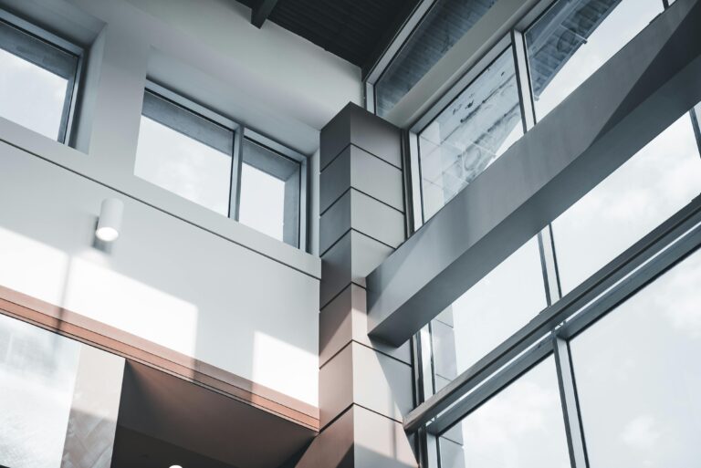 A modern architectural interior focusing on minimalist design and large windows.